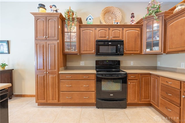 kitchen featuring light tile patterned floors and black appliances