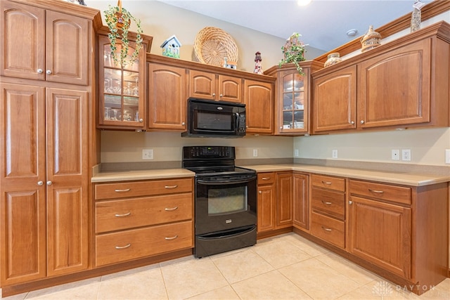 kitchen with light tile patterned floors and black appliances