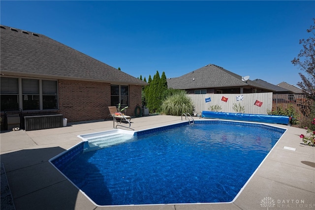 view of swimming pool with a patio area