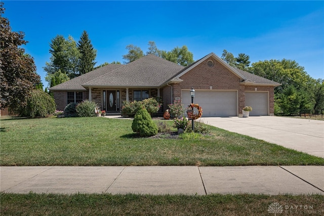 single story home featuring a garage and a front lawn