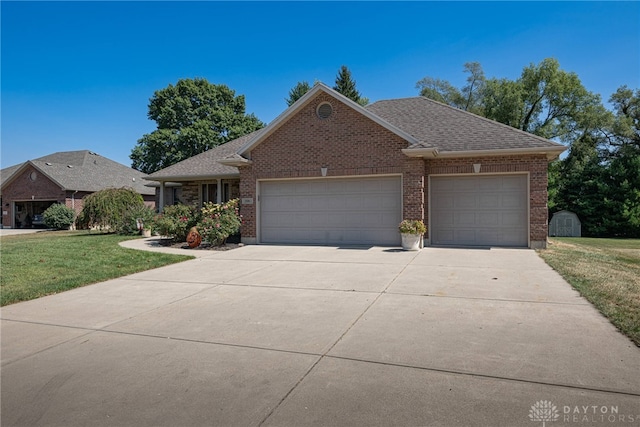 view of front of property with a garage and a front lawn