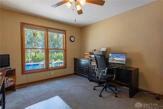 carpeted office space with ceiling fan