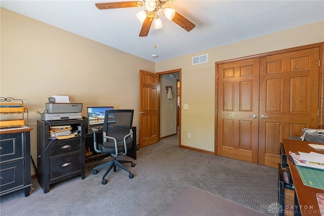 carpeted office featuring ceiling fan