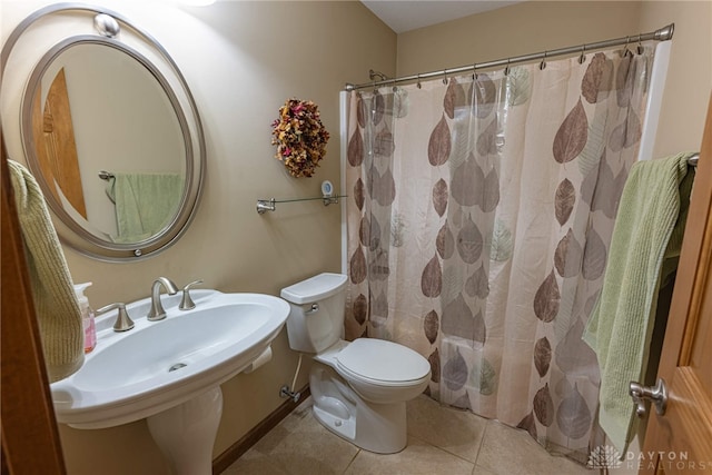 full bathroom with tile patterned flooring, sink, shower / bath combination with curtain, and toilet