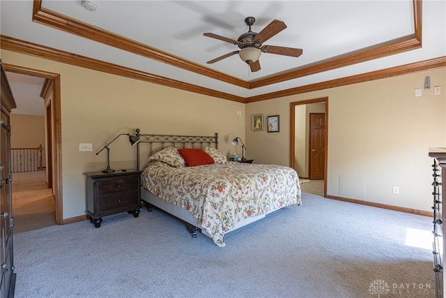 carpeted bedroom with crown molding, a raised ceiling, and ceiling fan