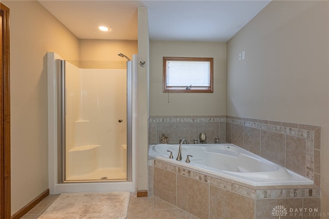 bathroom with shower with separate bathtub and tile patterned flooring