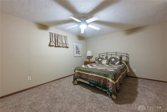 bedroom featuring ceiling fan, carpet, and a textured ceiling