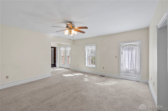 carpeted spare room with ceiling fan