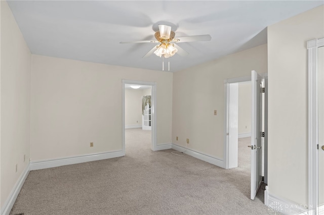 empty room featuring ceiling fan and light carpet