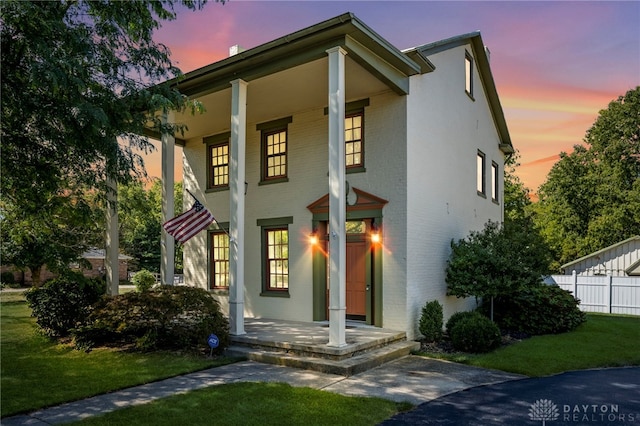 view of front facade featuring a porch and a yard