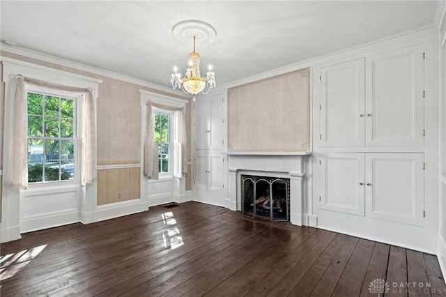 unfurnished living room with a notable chandelier, dark hardwood / wood-style flooring, and crown molding