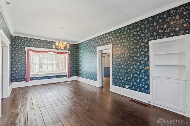 unfurnished dining area featuring a notable chandelier, built in features, wood-type flooring, and ornamental molding