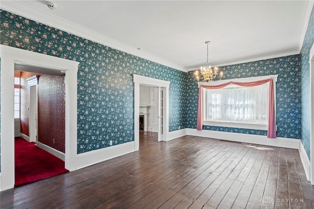 unfurnished dining area featuring a wealth of natural light, a chandelier, crown molding, and dark wood-type flooring