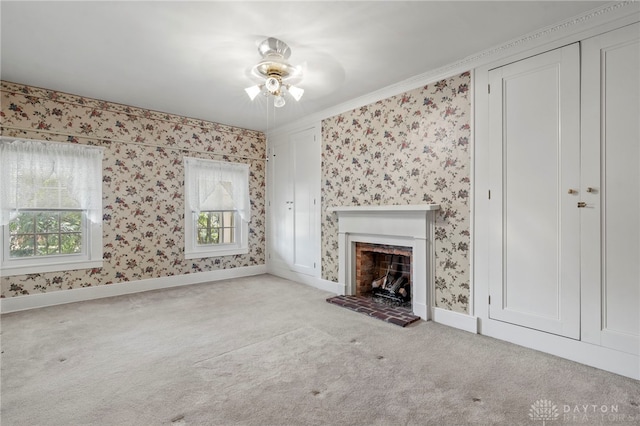 unfurnished living room with light colored carpet, ceiling fan, and crown molding