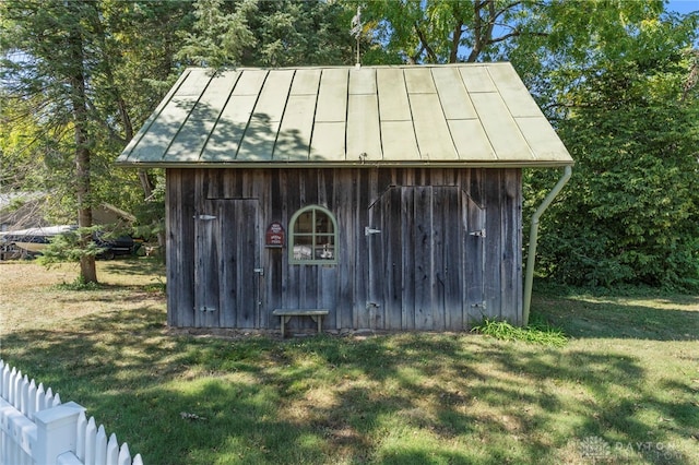 view of outbuilding featuring a yard