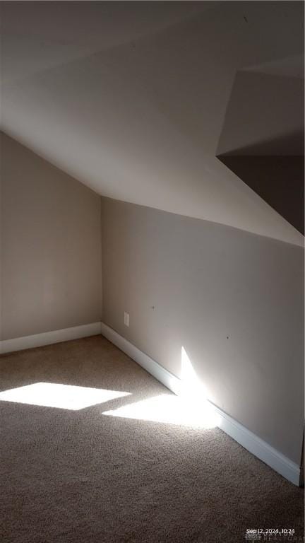 bonus room featuring baseboards, carpet, and vaulted ceiling