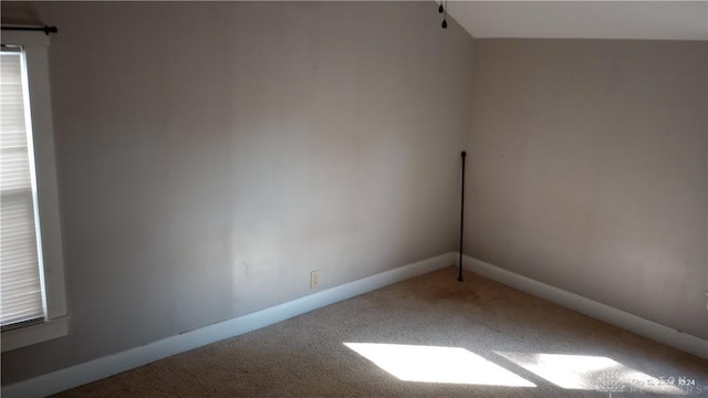 carpeted spare room featuring baseboards