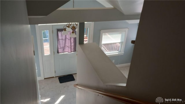 foyer with an inviting chandelier