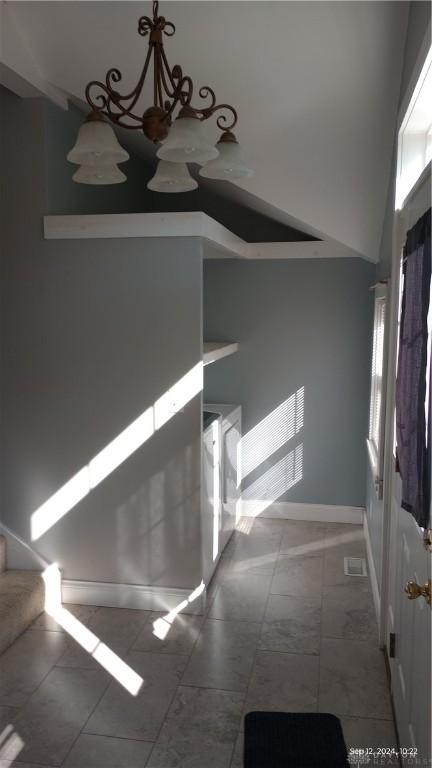 interior space featuring a high ceiling, stairway, and baseboards