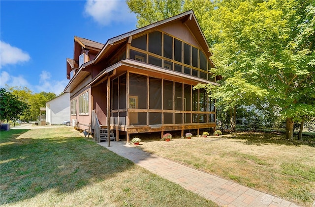 exterior space with a front lawn and a sunroom