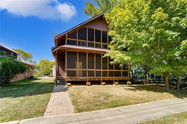 exterior space featuring a lawn and a sunroom