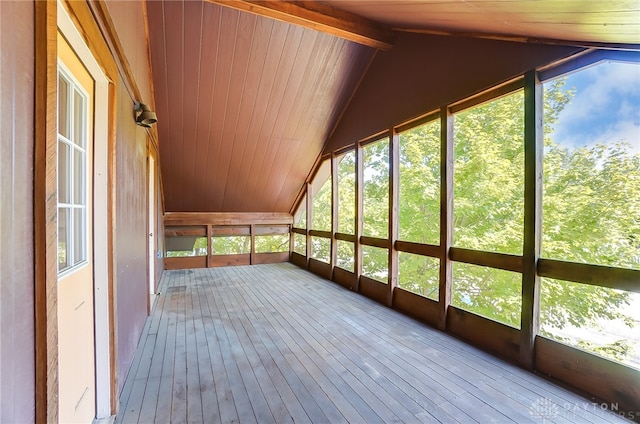 unfurnished sunroom with wooden ceiling and vaulted ceiling with beams