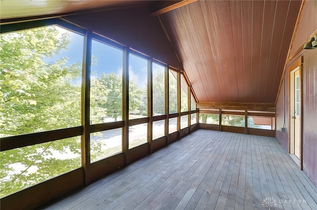 unfurnished sunroom with lofted ceiling, wood ceiling, and a wealth of natural light