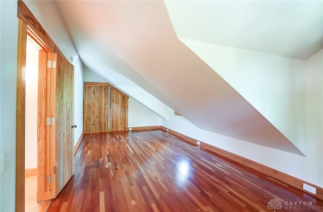 bonus room featuring lofted ceiling and wood-type flooring