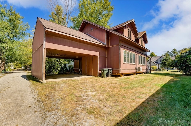 exterior space with a lawn and a carport