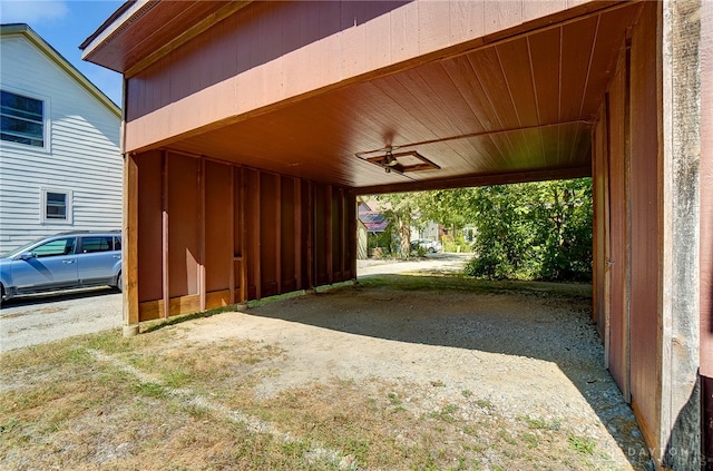 view of parking / parking lot featuring a carport