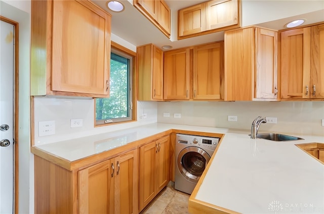 laundry room with washer / dryer, light tile patterned floors, cabinets, and sink