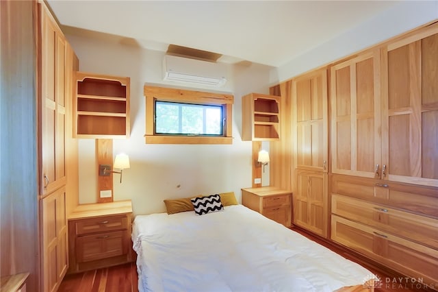 bedroom with an AC wall unit and dark hardwood / wood-style flooring