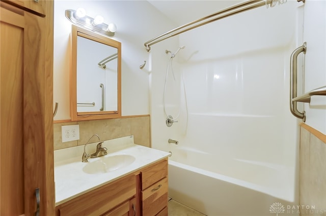 bathroom featuring vanity, backsplash, and tub / shower combination