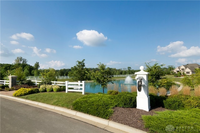 community / neighborhood sign featuring a water view