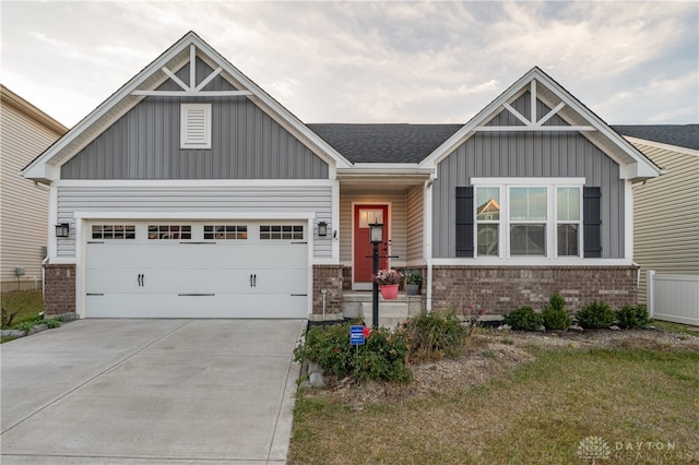 craftsman-style home with a garage and a front lawn