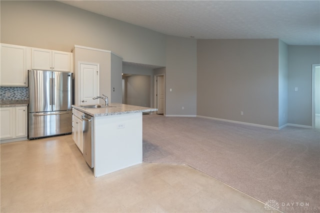 kitchen with white cabinetry, sink, light carpet, a center island with sink, and appliances with stainless steel finishes