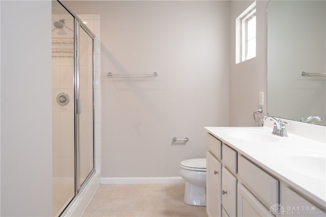 bathroom featuring walk in shower, tile patterned floors, vanity, and toilet