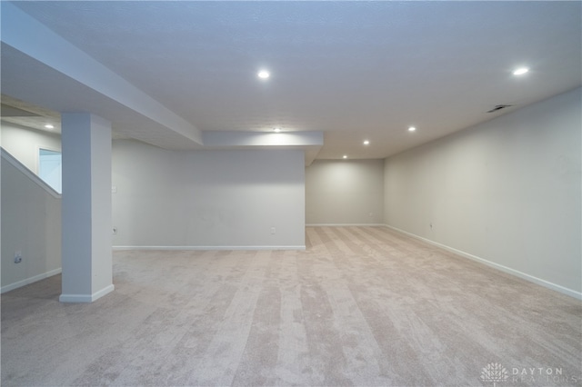 basement featuring light colored carpet