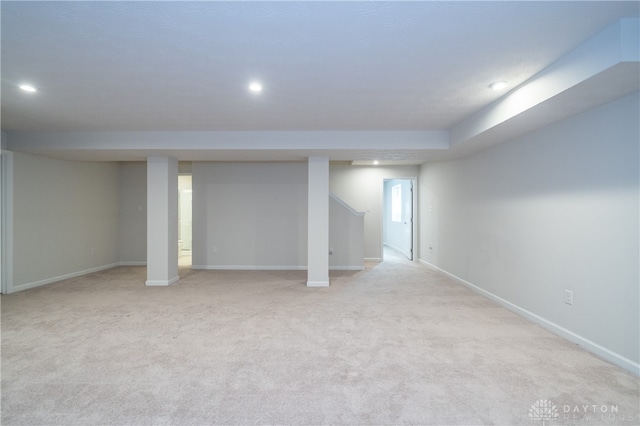 basement featuring light carpet