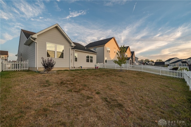 rear view of property featuring a yard