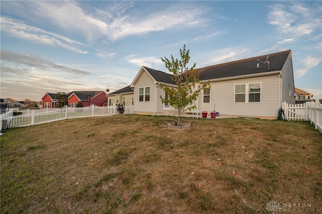 back of house featuring a yard