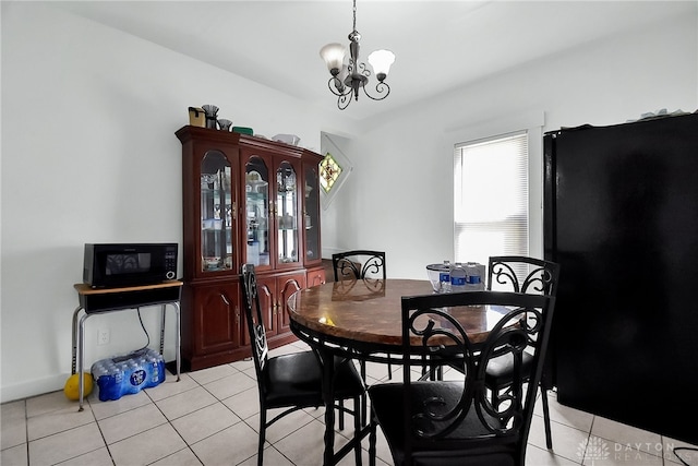 tiled dining area with a chandelier