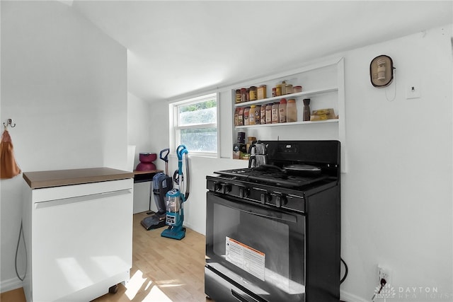 kitchen with black gas stove and light wood-type flooring