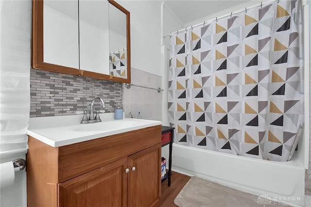 bathroom with vanity, shower / tub combo with curtain, hardwood / wood-style flooring, and backsplash