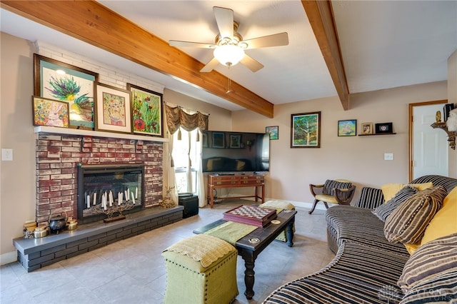 living room with ceiling fan, beam ceiling, and a brick fireplace