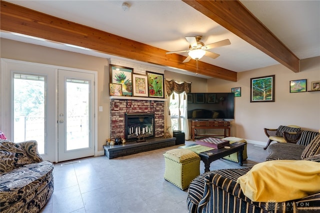 living room featuring ceiling fan, a fireplace, beamed ceiling, and french doors