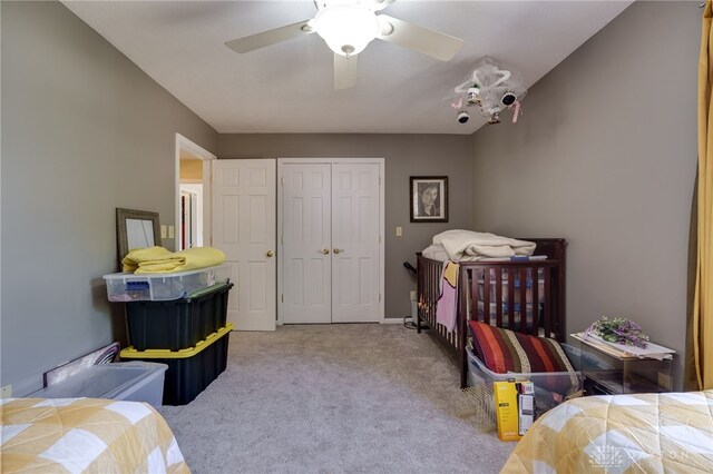 bedroom featuring light carpet, a closet, and ceiling fan