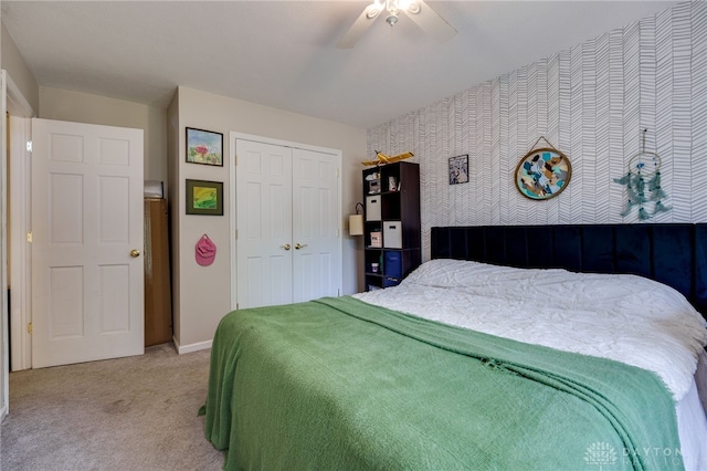 bedroom featuring carpet, ceiling fan, and a closet