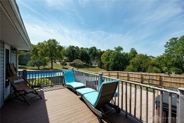 deck featuring a swimming pool