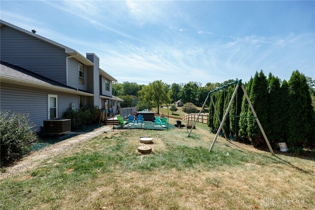 view of yard with a playground, cooling unit, and a wooden deck